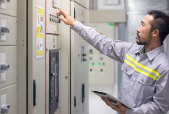 A man pointing at a machine