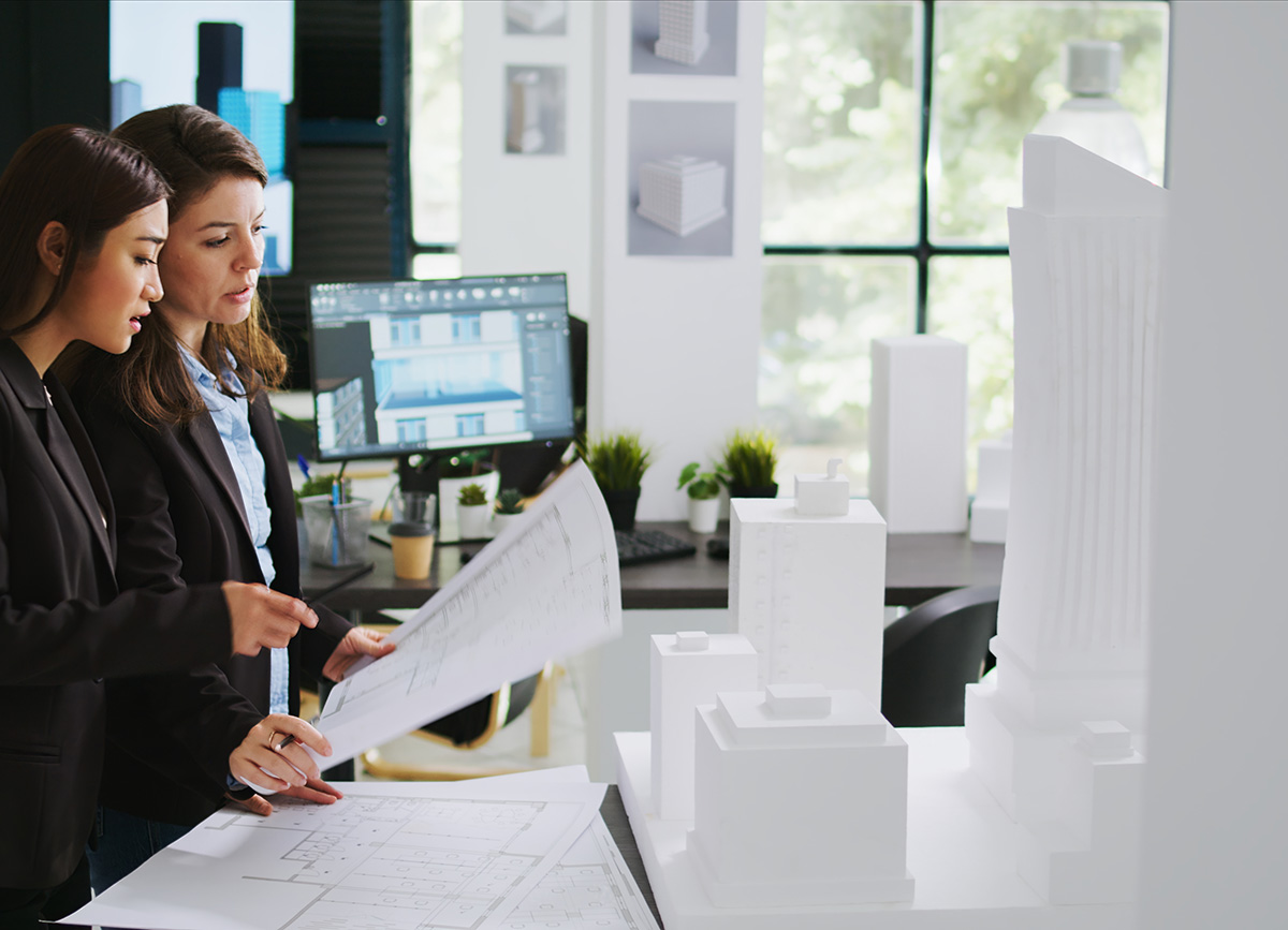 Two female corporate workers going over some paperwork.